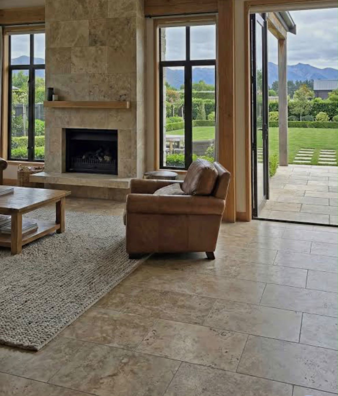 Travertine floor and matching stone fireplace surround